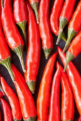 Image showing red chili or cayenne pepper on slate stone surface