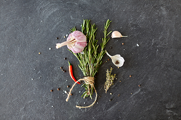 Image showing rosemary, garlic and chili pepper on stone surface