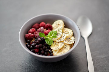 Image showing cereal breakfast with berries, banana and spoon