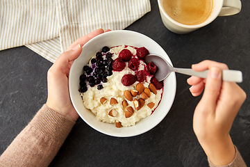 Image showing hands with porridge breakfast and cup of coffee