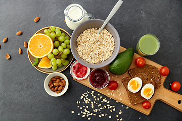 Image showing oatmeal, fruits, toast bread, egg, jam and milk