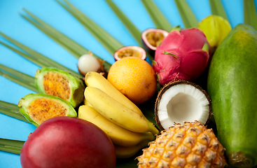 Image showing different exotic fruits on blue background