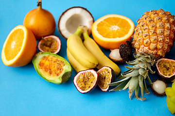 Image showing different exotic fruits on blue background