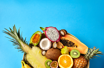 Image showing plate of exotic fruits on blue background