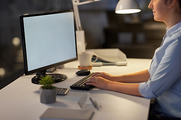 Image showing businesswoman working on computer at night office