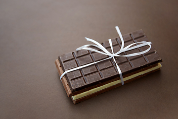 Image showing different kinds of chocolate on brown background