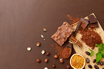 Image showing chocolate with hazelnuts, cocoa beans and powder