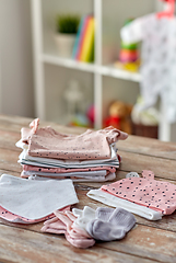 Image showing baby clothes on wooden table at home