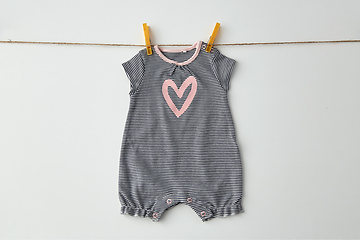 Image showing bodysuit for baby girl hanging on rope with pins