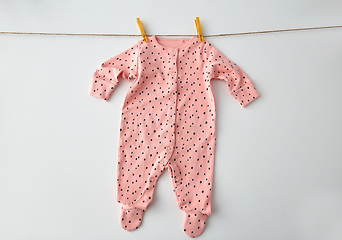 Image showing bodysuit for baby girl hanging on rope with pins