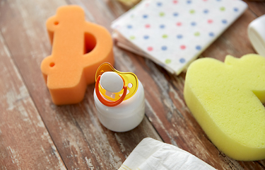 Image showing baby accessories for bathing on wooden table