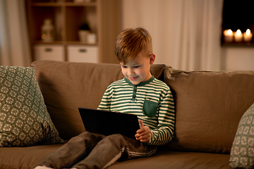 Image showing happy little boy with tablet computer at home