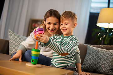 Image showing mother and son playing with toy pyramid at home