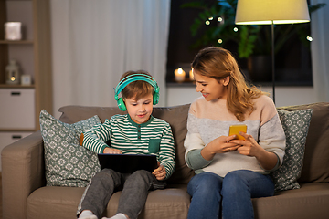 Image showing mother and son using gadgets at home