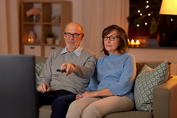 Image showing senior couple watching tv at home in evening