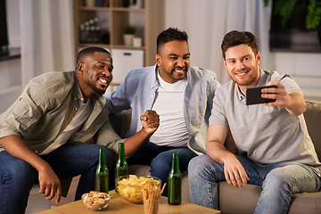 Image showing male friends with smartphone taking selfie at home