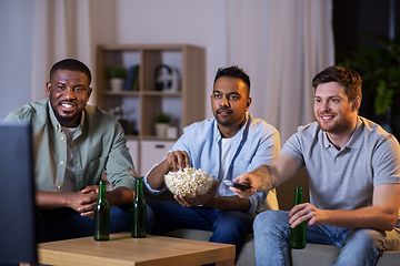 Image showing happy male friends with beer watching tv at home