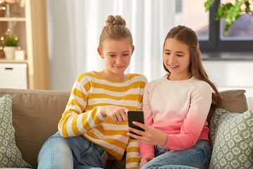 Image showing happy teenage girls with smartphone at home