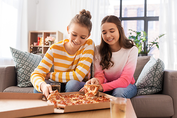 Image showing happy teenage girls eating takeaway pizza at home