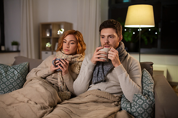 Image showing sick young couple drinking hot tea at home