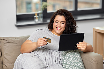 Image showing woman with tablet pc and credit card at home