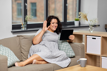 Image showing woman with tablet pc having video chat at home