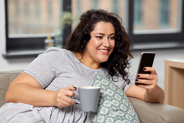 Image showing woman with smartphone drinking coffee at home