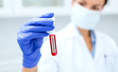 Image showing scientist holding test tube with coronavirus