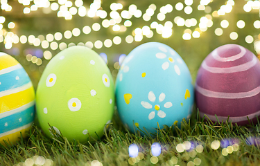 Image showing row of colored easter eggs on artificial grass