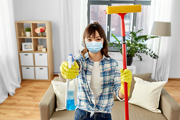 Image showing asian woman in protective mask cleaning home