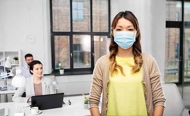 Image showing asian woman in protective medical mask at office