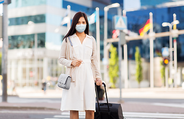 Image showing asian woman with travel bag in protective mask