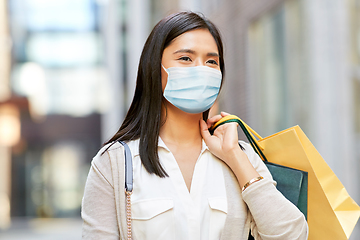 Image showing asian woman in protective mask with shopping bags