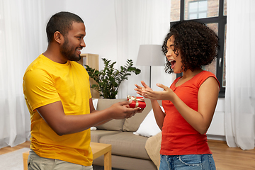 Image showing happy african american couple with red gift box