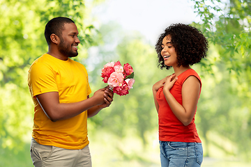 Image showing happy african american couple with flowers