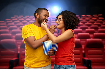 Image showing happy african american couple eating popcorn