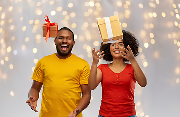 Image showing happy african american couple throwing gift boxes