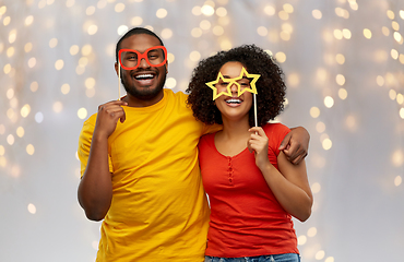 Image showing happy african american couple with party props