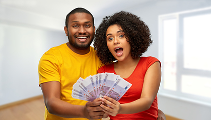 Image showing african american couple with money at new home