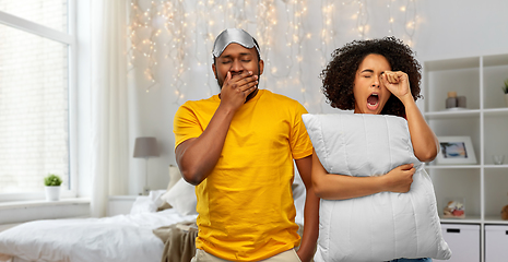 Image showing sleepy african american couple over bedroom