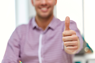 Image showing happy young man showing thumbs up