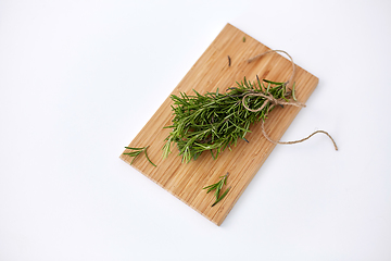 Image showing bunch of rosemary on wooden cutting board