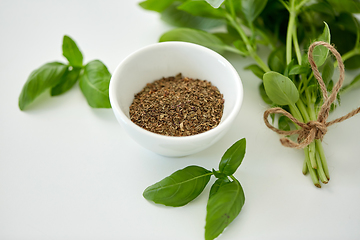 Image showing fresh basil and dry seasoning on white background