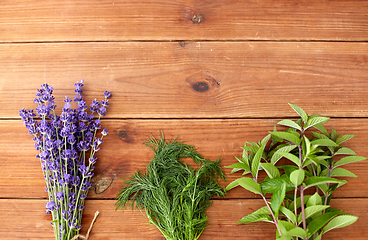 Image showing lavender, dill and peppermint on wooden background