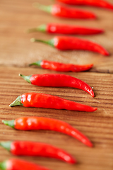 Image showing red chili or cayenne pepper on wooden boards