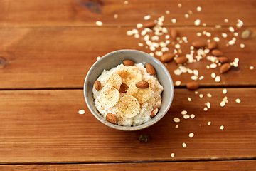 Image showing oatmeal with banana and almond on wooden table