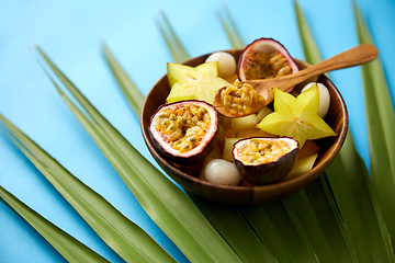 Image showing mix of exotic fruits in wooden plate with spoon