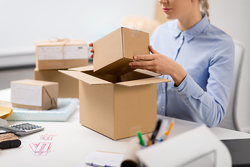 Image showing woman packing parcel box at post office