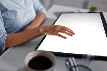 Image showing hand on led light tablet at night office