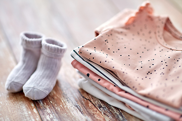 Image showing close up of baby clothes on wooden table